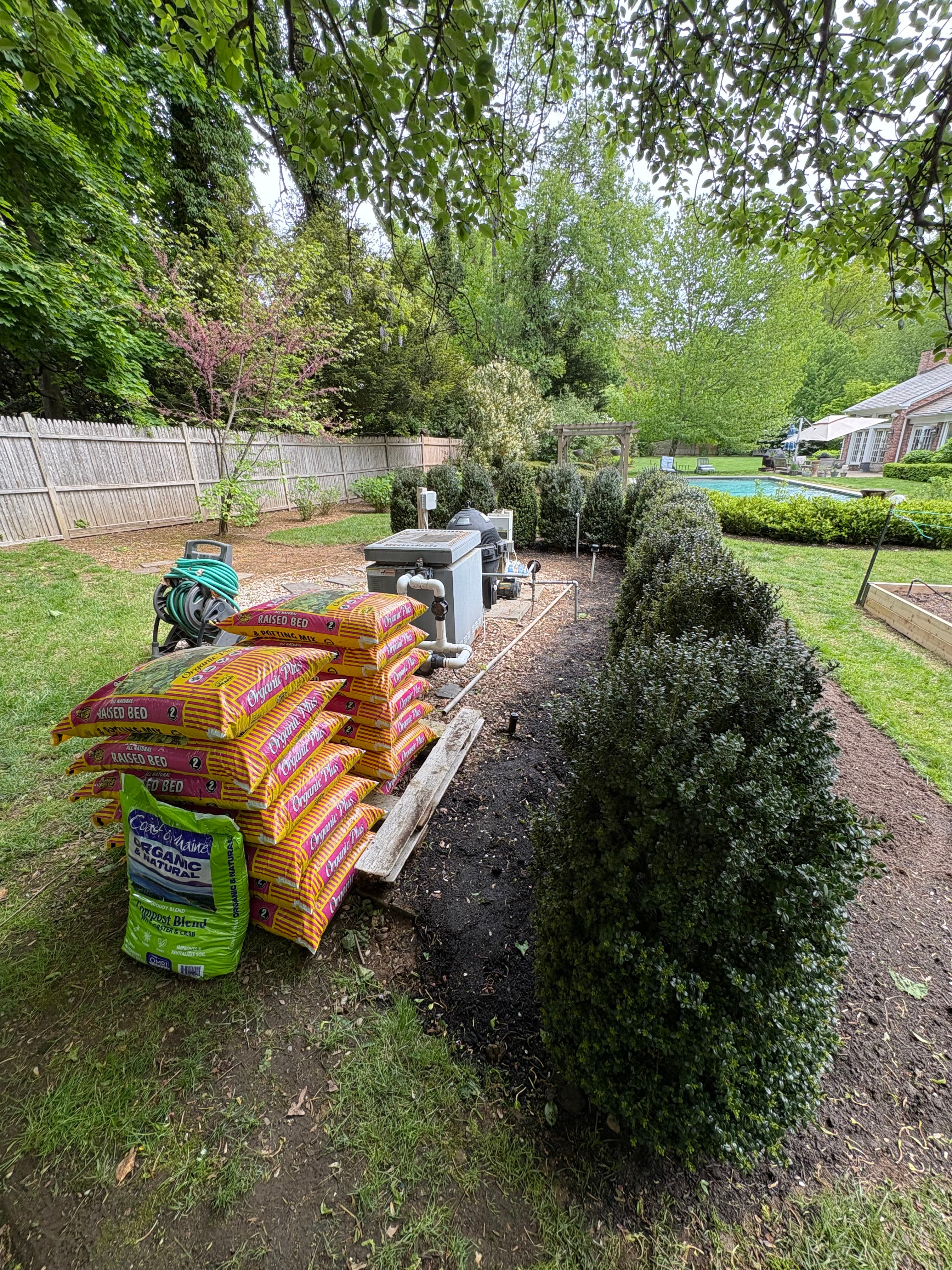 Final Result after plant installation and brush removal, organized planting materials for client